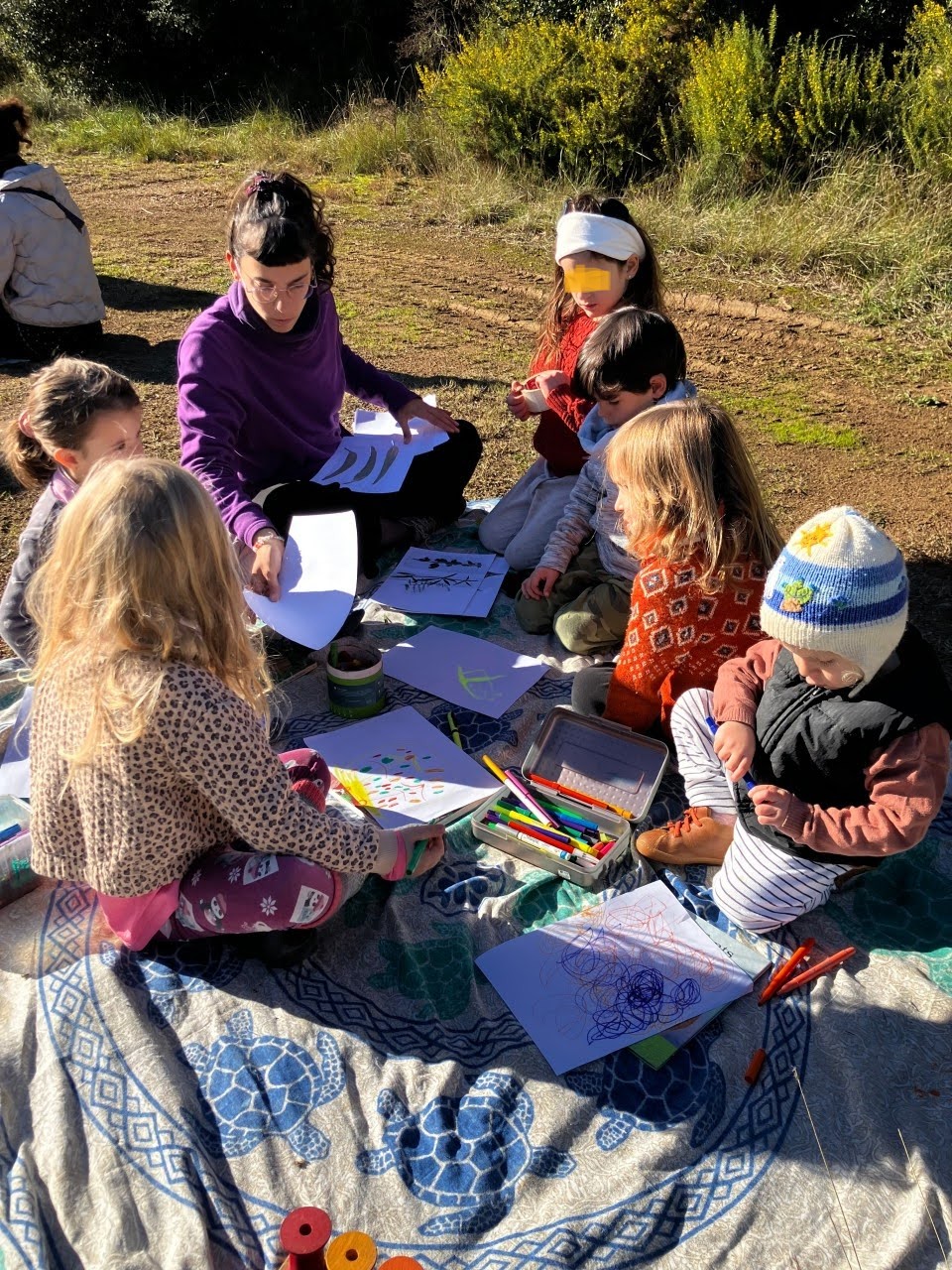 Teacher working with Pre-Kindergarten children outdoors